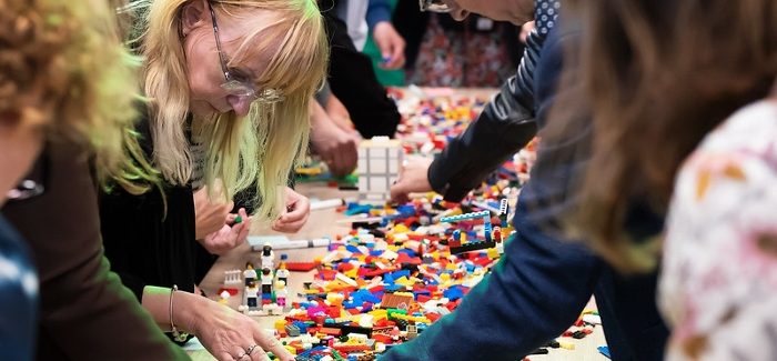 People building with LEGOs.